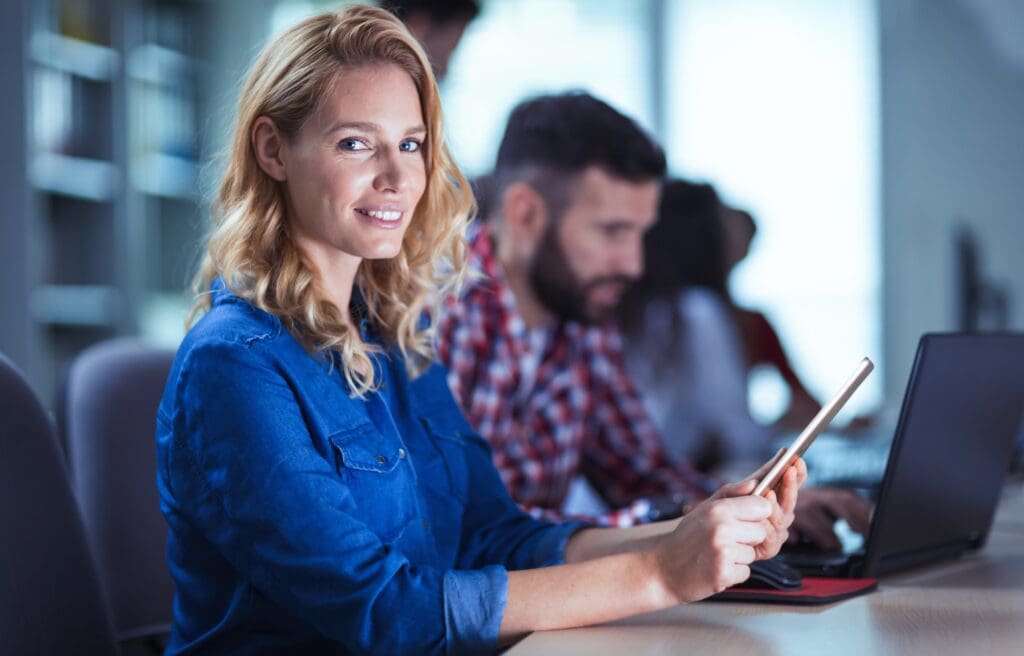 Blonde woman working at information technology company