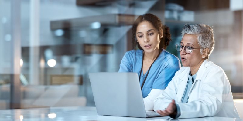 Team of doctors, healthcare and women with laptop, working together and digital hospital schedule o